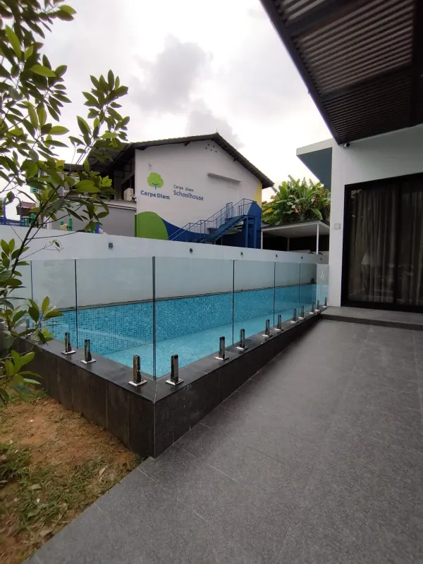 View of completed frameless pool fence from garden side