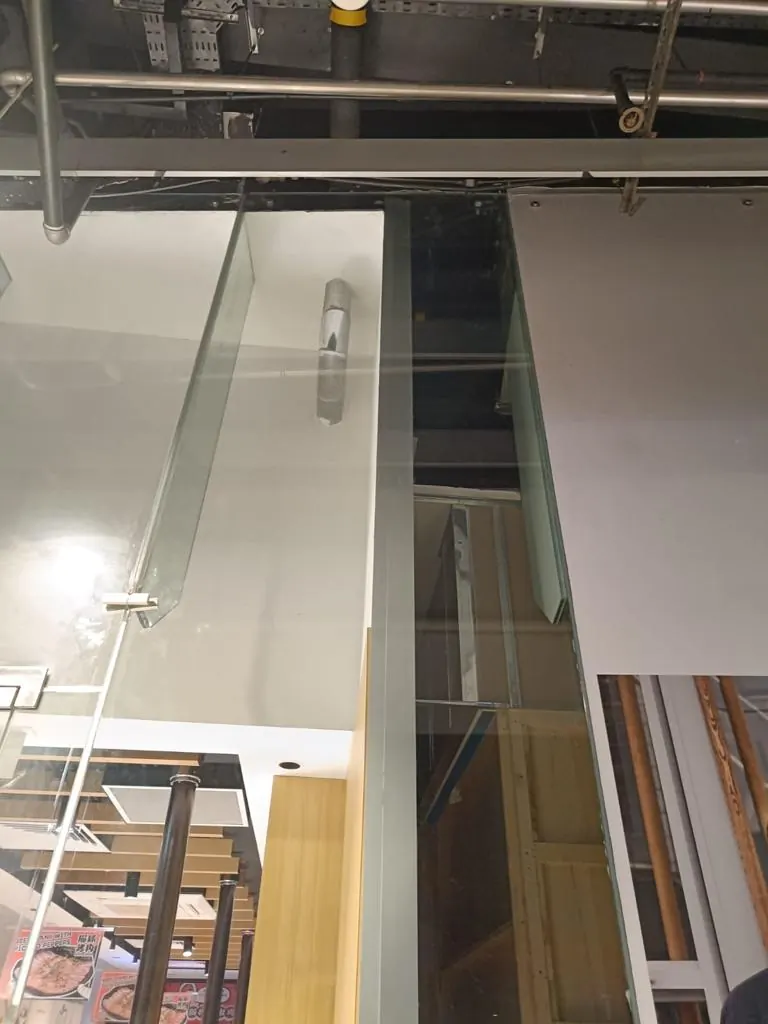 Full height view of the 5.2m tempered glass panel installed in mall interior
