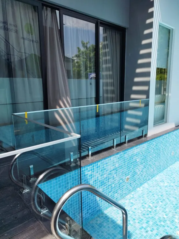 Wide angle showing pool glass barrier along the pool edge