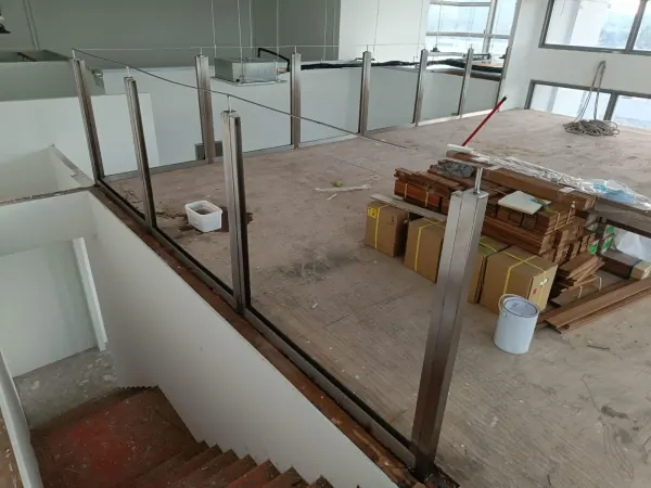 View from upper floor showing glass handrail and timber bannister continuity