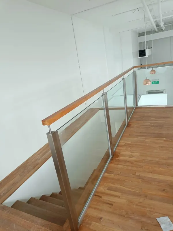 Glass railing with round wooden handrails installed in landed bungalow along Bukit Timah Road
